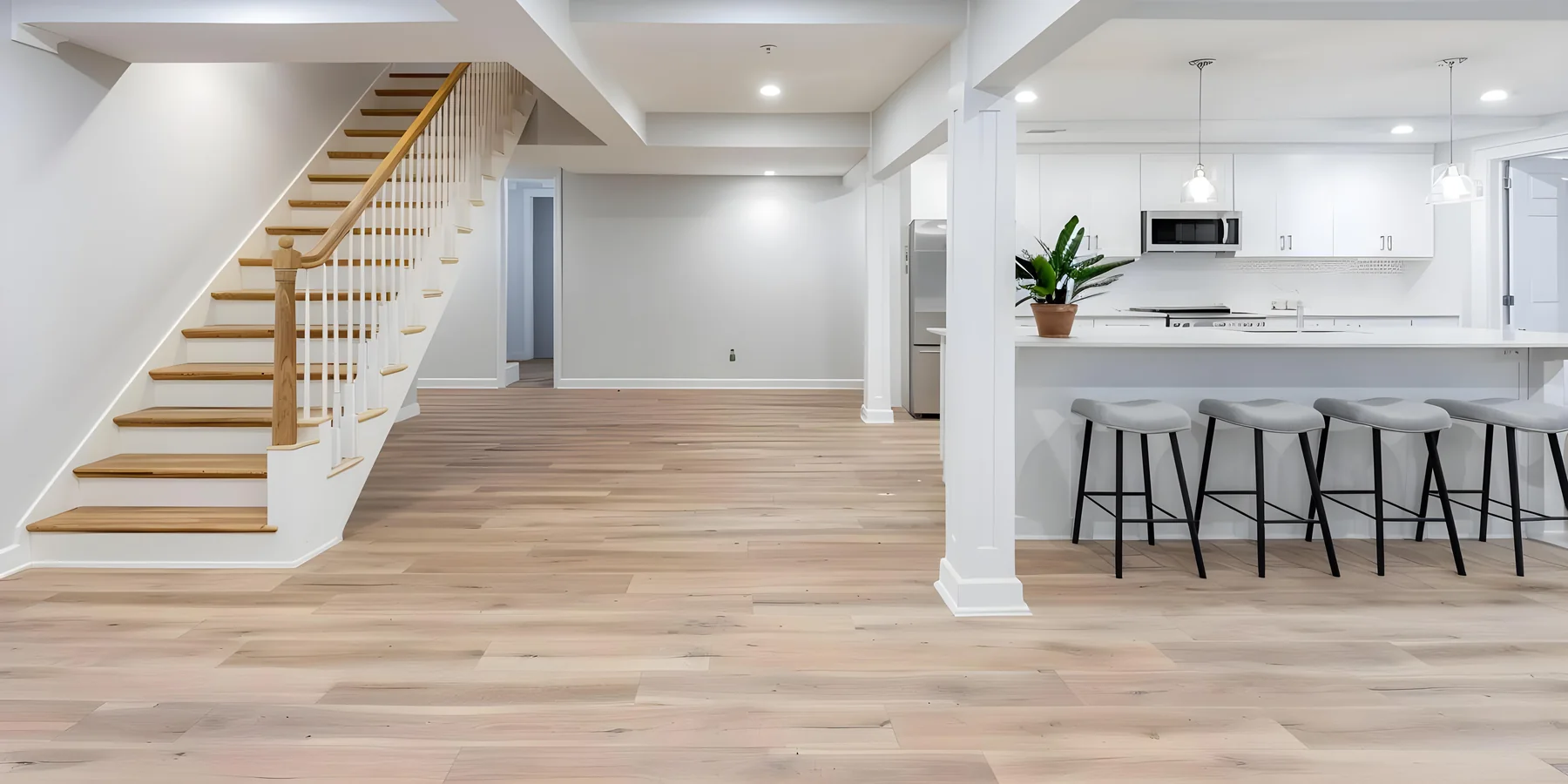 Finished basement living space with a bar counter and recessed lighting