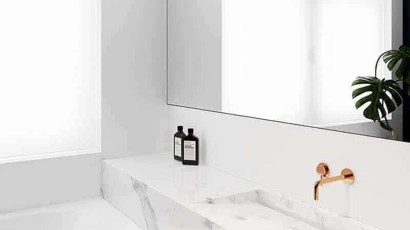 Modern bathroom remodel with marble sink, gold faucet, and sleek mirror by an Arlington general contractor