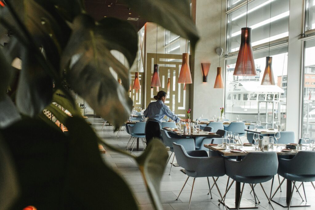 Luxurious high-end dining room of a renovated restaurant in DC with elegant lighting and sophisticated décor.
