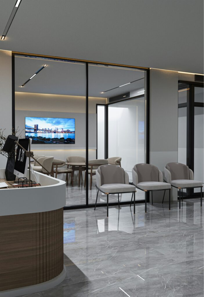 Renovated office waiting room with modern front desk, ergonomic chairs, and glass-walled meeting rooms by a general contractor in Arlington VA.