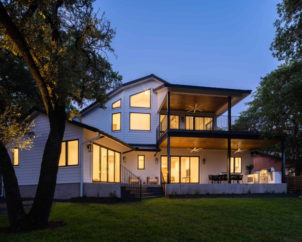 Twilight view of modern two-story house with outdoor patio