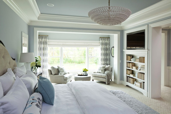 Spacious bedroom with white and light blue decor