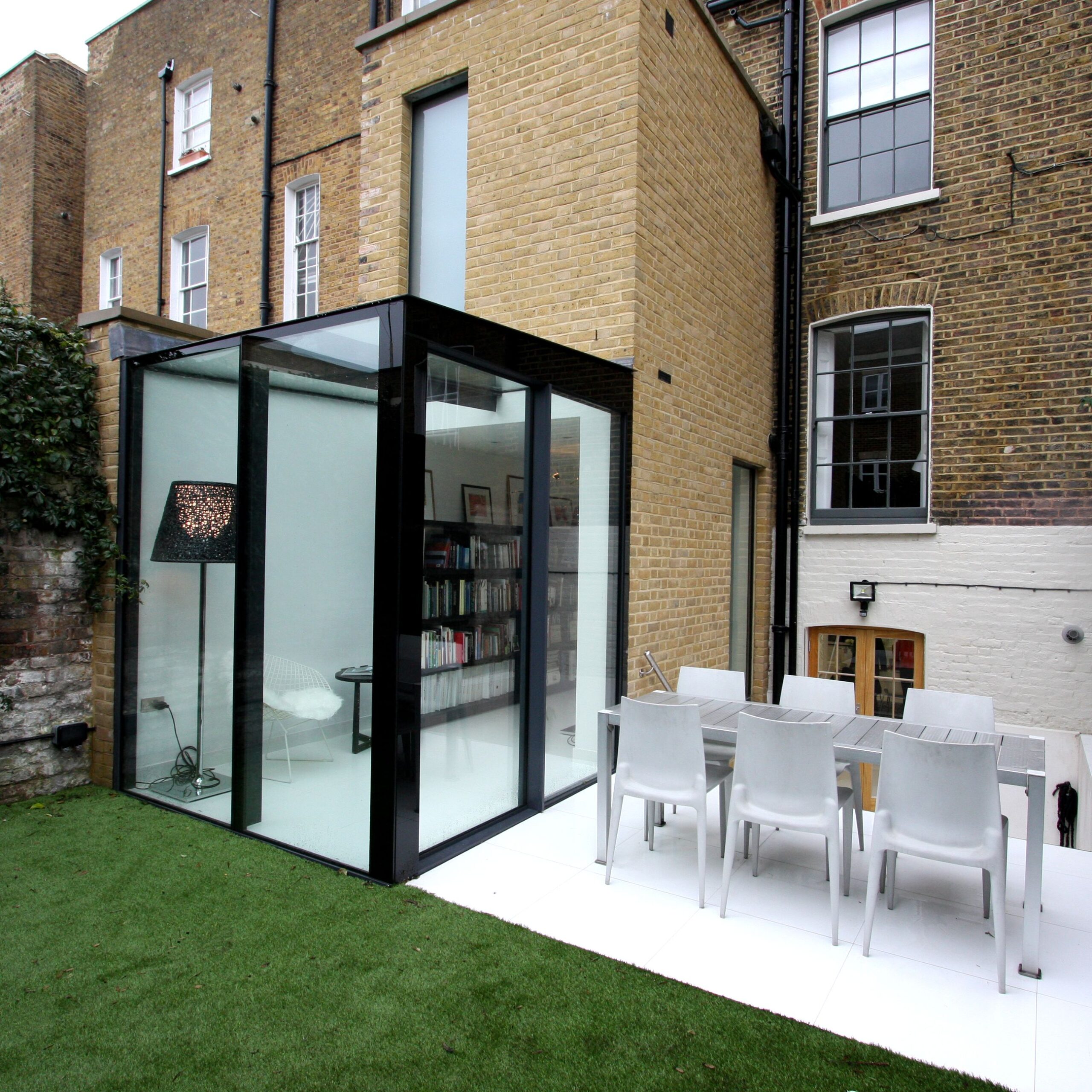 Outdoor patio attached to brick building with modern furnishings