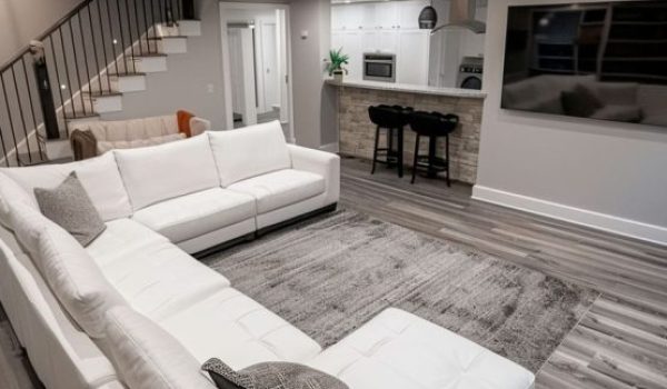 Contemporary Basement Renovation | Alexandria Home Remodeling Services Modern Alexandria basement renovation with light wood flooring, gray and white walls, and recessed overhead lighting.
